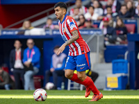 Angel Correa of Atletico de Madrid is in action with the ball during the La Liga EA Sports 2024/25 football match between Atletico de Madrid...