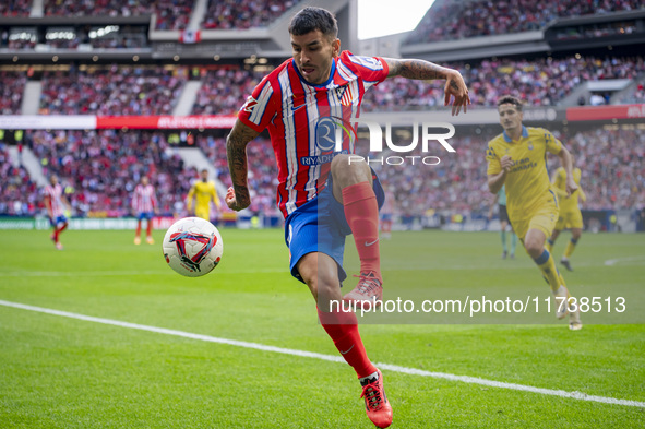 Angel Correa of Atletico de Madrid is in action with the ball during the La Liga EA Sports 2024/25 football match between Atletico de Madrid...