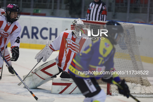 A hockey match between KS Cracovia 1906 (reds) and MMKS Podhale Nowy Targ (blues) takes place at the Adam 'Roch' Kowalski ice rink on the oc...