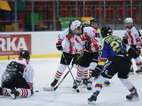 A hockey match between KS Cracovia 1906 (reds) and MMKS Podhale Nowy Targ (blues) takes place at the Adam 'Roch' Kowalski ice rink on the oc...