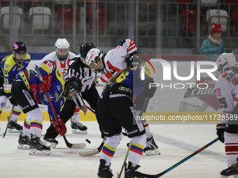 A hockey match between KS Cracovia 1906 (reds) and MMKS Podhale Nowy Targ (blues) takes place at the Adam 'Roch' Kowalski ice rink on the oc...