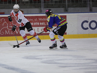 A hockey match between KS Cracovia 1906 (reds) and MMKS Podhale Nowy Targ (blues) takes place at the Adam 'Roch' Kowalski ice rink on the oc...