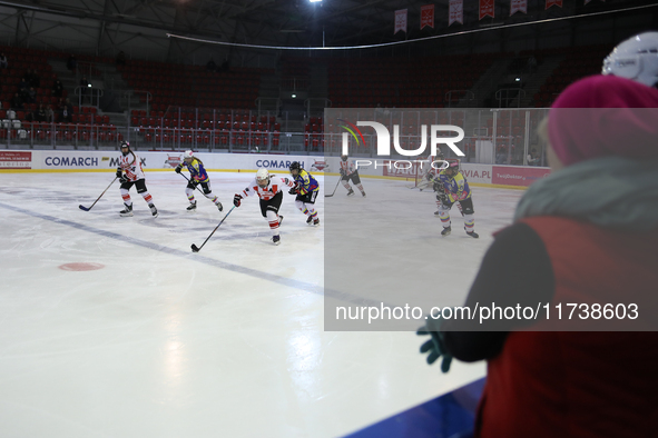 A hockey match between KS Cracovia 1906 (reds) and MMKS Podhale Nowy Targ (blues) takes place at the Adam 'Roch' Kowalski ice rink on the oc...