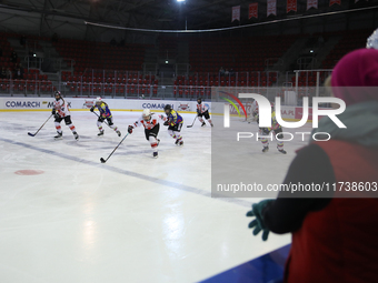 A hockey match between KS Cracovia 1906 (reds) and MMKS Podhale Nowy Targ (blues) takes place at the Adam 'Roch' Kowalski ice rink on the oc...