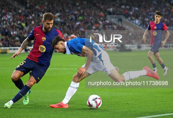 Inigo Martinez and Jofre Carreras play during the match between FC Barcelona and RCD Espanyol, corresponding to week 12 of LaLiga EA Sports,...