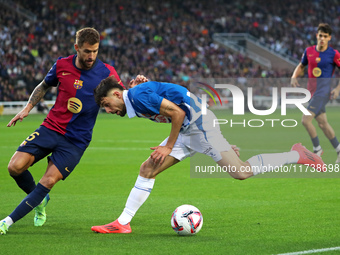 Inigo Martinez and Jofre Carreras play during the match between FC Barcelona and RCD Espanyol, corresponding to week 12 of LaLiga EA Sports,...