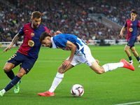 Inigo Martinez and Jofre Carreras play during the match between FC Barcelona and RCD Espanyol, corresponding to week 12 of LaLiga EA Sports,...