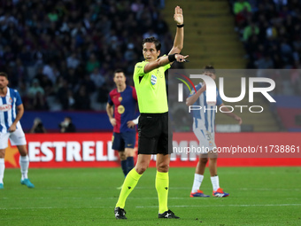 The referee Jose Luis Munuera Montero officiates the match between FC Barcelona and RCD Espanyol, corresponding to week 12 of LaLiga EA Spor...