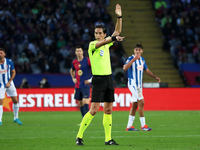 The referee Jose Luis Munuera Montero officiates the match between FC Barcelona and RCD Espanyol, corresponding to week 12 of LaLiga EA Spor...