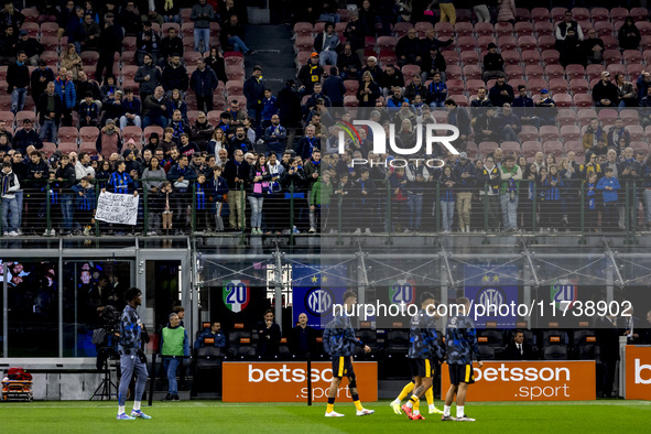 FC Internazionale supporters watch the warm-up during the Serie A match between FC Internazionale and Venezia FC at Giuseppe Meazza Stadium...