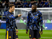 Benjamin Pavard and Marcus Thuram talk during the Serie A match between FC Internazionale and Venezia FC at Giuseppe Meazza Stadium in Milan...