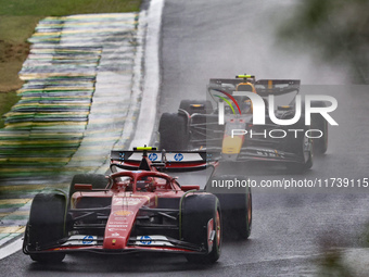 Charles Leclerc of Monaco drives the (16) Scuderia Ferrari SF-24 Ferrari, and Sergio Perez of Mexico drives the (11) Oracle Red Bull Racing...