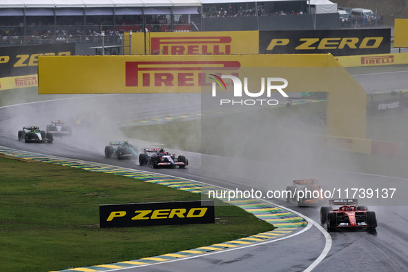 Charles Leclerc of Monaco drives the (16) Scuderia Ferrari SF-24 Ferrari and leads the group during the Formula 1 Lenovo Grande Premio De Sa...