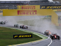 Charles Leclerc of Monaco drives the (16) Scuderia Ferrari SF-24 Ferrari and leads the group during the Formula 1 Lenovo Grande Premio De Sa...