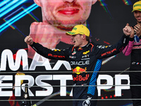 Max Verstappen of the Netherlands drives the Oracle Red Bull Racing RB20 Honda RBPT and wins the race on the podium during the Formula 1 Len...