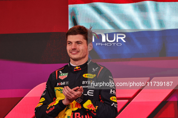 Max Verstappen of the Netherlands drives the Oracle Red Bull Racing RB20 Honda RBPT and wins the race on the podium during the Formula 1 Len...