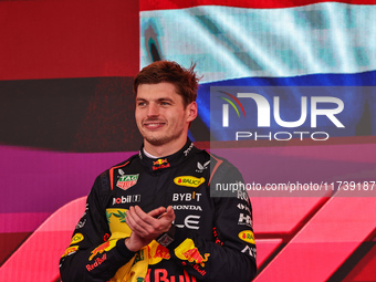 Max Verstappen of the Netherlands drives the Oracle Red Bull Racing RB20 Honda RBPT and wins the race on the podium during the Formula 1 Len...