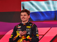 Max Verstappen of the Netherlands drives the Oracle Red Bull Racing RB20 Honda RBPT and wins the race on the podium during the Formula 1 Len...