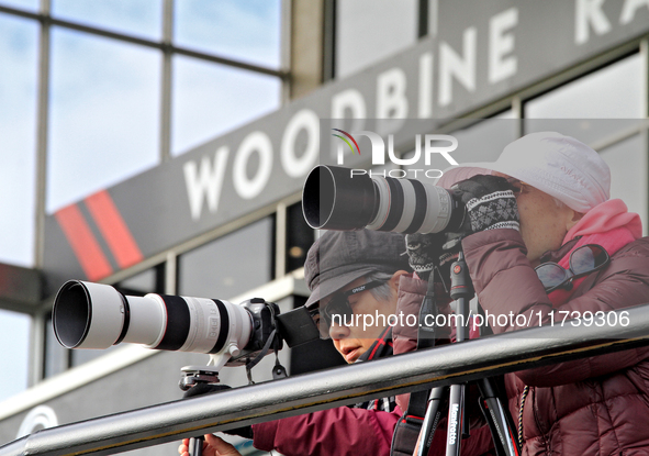 Race fans photograph the action during a race at Woodbine Racetrack in Toronto, Canada, on November 3, 2024. 