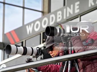 Race fans photograph the action during a race at Woodbine Racetrack in Toronto, Canada, on November 3, 2024. (