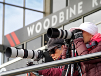 Race fans photograph the action during a race at Woodbine Racetrack in Toronto, Canada, on November 3, 2024. (