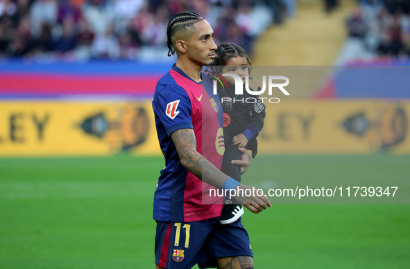 Raphinha Dias is with his son Gael during the match between FC Barcelona and RCD Espanyol, corresponding to week 12 of LaLiga EA Sports, at...