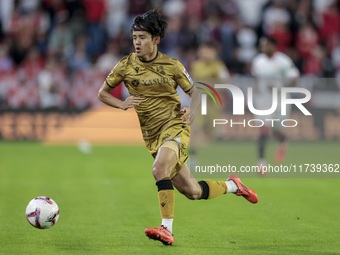 Takefusa Kubo of Real Sociedad runs with the ball during the La Liga EA Sports match between Sevilla FC and Real Sociedad at Sanchez Pizjuan...