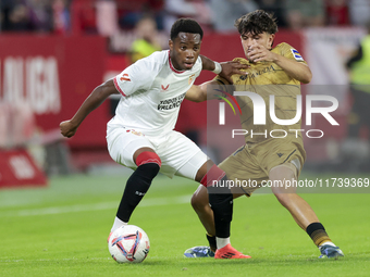 In Seville, Spain, on November 3, 2024, Idumbo of Sevilla FC competes for the ball with Jon Aramburu of Real Sociedad during the La Liga EA...