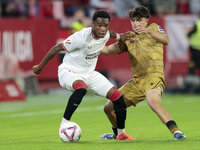 In Seville, Spain, on November 3, 2024, Idumbo of Sevilla FC competes for the ball with Jon Aramburu of Real Sociedad during the La Liga EA...