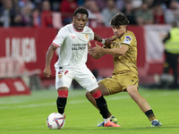 In Seville, Spain, on November 3, 2024, Idumbo of Sevilla FC competes for the ball with Jon Aramburu of Real Sociedad during the La Liga EA...