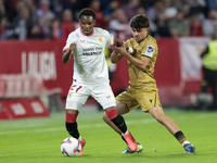 In Seville, Spain, on November 3, 2024, Idumbo of Sevilla FC competes for the ball with Jon Aramburu of Real Sociedad during the La Liga EA...