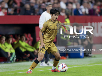 Takefusa Kubo of Real Sociedad controls the ball during the La Liga EA Sports match between Sevilla FC and Real Sociedad at Sanchez Pizjuan...