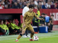 Takefusa Kubo of Real Sociedad controls the ball during the La Liga EA Sports match between Sevilla FC and Real Sociedad at Sanchez Pizjuan...