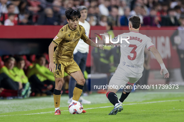 Takefusa Kubo of Real Sociedad competes for the ball with Adria Pedrosa of Sevilla FC during the La Liga EA Sports match between Sevilla FC...