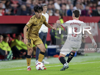 Takefusa Kubo of Real Sociedad competes for the ball with Adria Pedrosa of Sevilla FC during the La Liga EA Sports match between Sevilla FC...