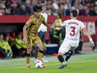 Takefusa Kubo of Real Sociedad competes for the ball with Adria Pedrosa of Sevilla FC during the La Liga EA Sports match between Sevilla FC...