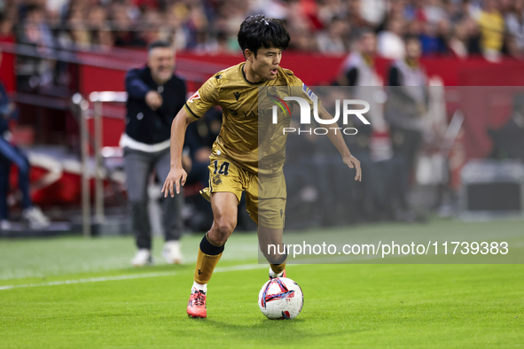 Takefusa Kubo of Real Sociedad runs with the ball during the La Liga EA Sports match between Sevilla FC and Real Sociedad at Sanchez Pizjuan...