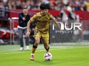 Takefusa Kubo of Real Sociedad runs with the ball during the La Liga EA Sports match between Sevilla FC and Real Sociedad at Sanchez Pizjuan...