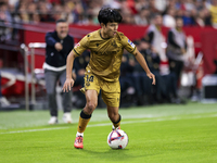 Takefusa Kubo of Real Sociedad runs with the ball during the La Liga EA Sports match between Sevilla FC and Real Sociedad at Sanchez Pizjuan...