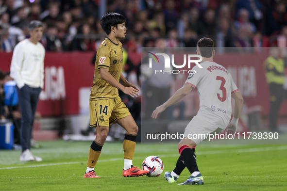 Takefusa Kubo of Real Sociedad battles for the ball during the La Liga EA Sports match between Sevilla FC and Real Sociedad at Sanchez Pizju...