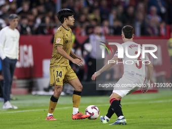 Takefusa Kubo of Real Sociedad battles for the ball during the La Liga EA Sports match between Sevilla FC and Real Sociedad at Sanchez Pizju...