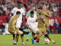 Isaac Romero of Sevilla FC competes for the ball with Brais Mendez of Real Sociedad during the La Liga EA Sports match between Sevilla FC an...