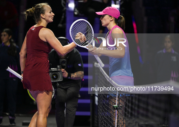 RIYADH, SAUDI ARABIA - NOVEMBER 03: Barbora Krejcikovas of Czech Republic congratulates Iga Swiatek of Poland on day 2 of the 2024 WTA Final...