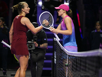 RIYADH, SAUDI ARABIA - NOVEMBER 03: Barbora Krejcikovas of Czech Republic congratulates Iga Swiatek of Poland on day 2 of the 2024 WTA Final...