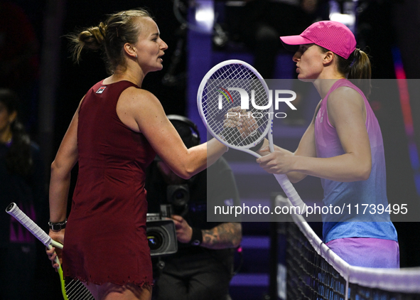 RIYADH, SAUDI ARABIA - NOVEMBER 03: Barbora Krejcikovas of Czech Republic congratulates Iga Swiatek of Poland on day 2 of the 2024 WTA Final...