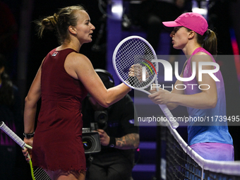 RIYADH, SAUDI ARABIA - NOVEMBER 03: Barbora Krejcikovas of Czech Republic congratulates Iga Swiatek of Poland on day 2 of the 2024 WTA Final...