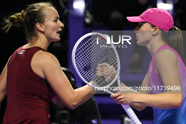 RIYADH, SAUDI ARABIA - NOVEMBER 03: Barbora Krejcikovas of Czech Republic congratulates Iga Swiatek of Poland on day 2 of the 2024 WTA Final...