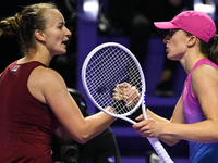 RIYADH, SAUDI ARABIA - NOVEMBER 03: Barbora Krejcikovas of Czech Republic congratulates Iga Swiatek of Poland on day 2 of the 2024 WTA Final...