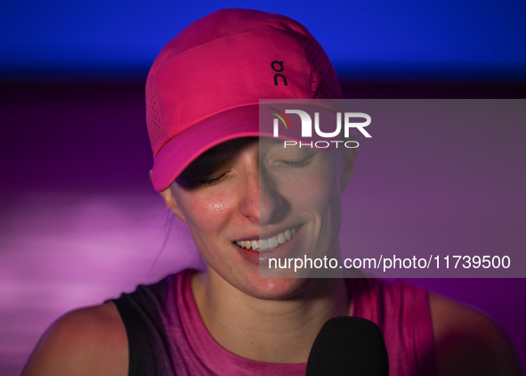 RIYADH, SAUDI ARABIA - NOVEMBER 03: Iga Swiatek of Poland speaks to the media after winning her opening match against Barbora Krejcikova of...