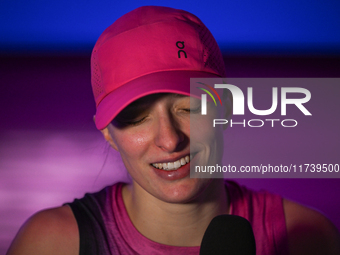 RIYADH, SAUDI ARABIA - NOVEMBER 03: Iga Swiatek of Poland speaks to the media after winning her opening match against Barbora Krejcikova of...